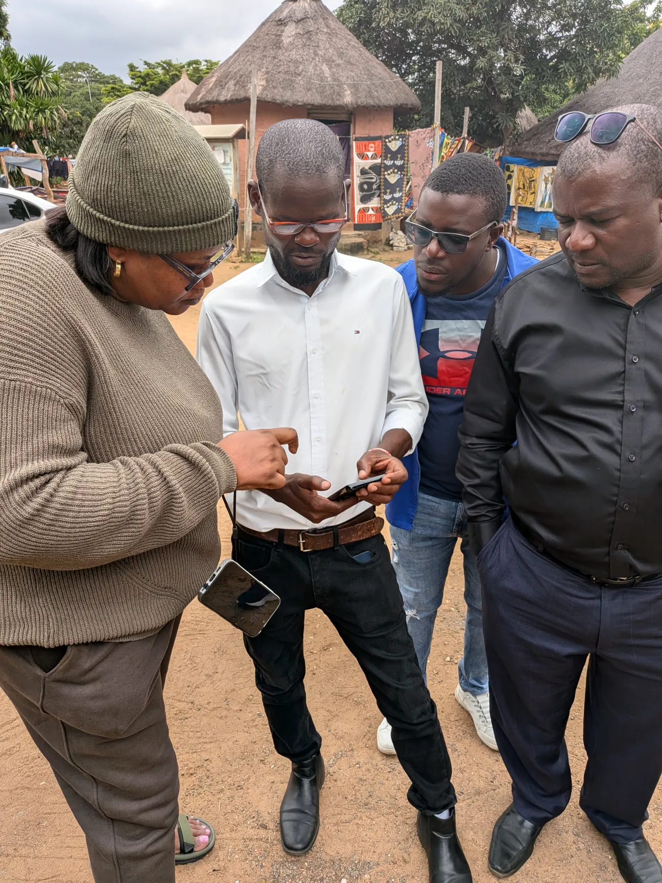 Testing the EBS mobile application in the field: surveillance officers and a community healthcare volunteer record a health signal in Lusaka.