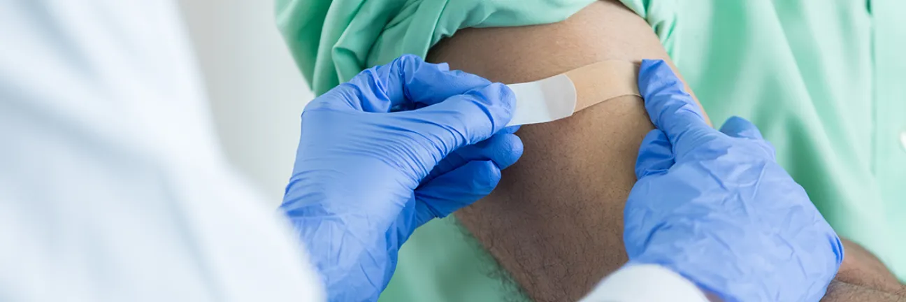 Vaccination by doctor wearing gloves