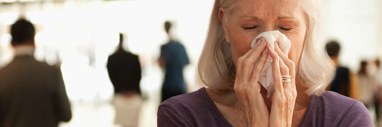Woman wiping her nose. © Istock