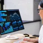 Female doctor typing and looking at data on screen