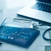 Tablet with data next to laptop