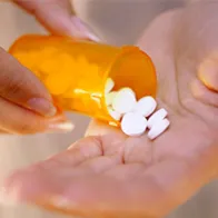 Pills in hand. © Istock