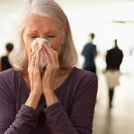 Woman wiping her nose. © Istock