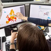 ECDC experts looking at a screen with data