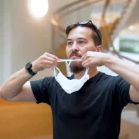 Man putting on face mask