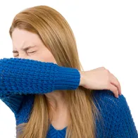 Sick woman sneezing