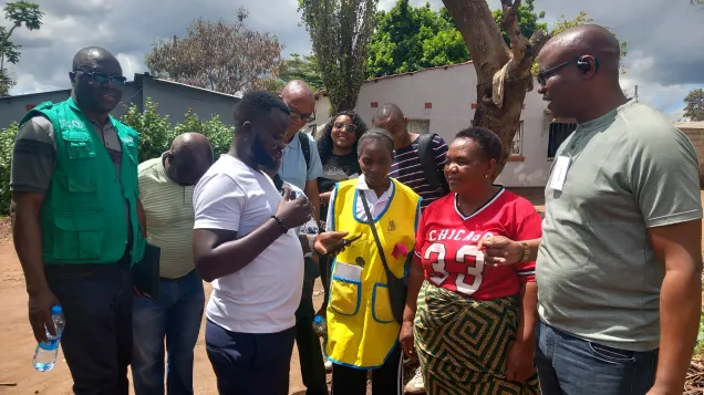 Testing the EBS mobile application in the field: surveillance officers and a community healthcare volunteer record a health signal in Lusaka.