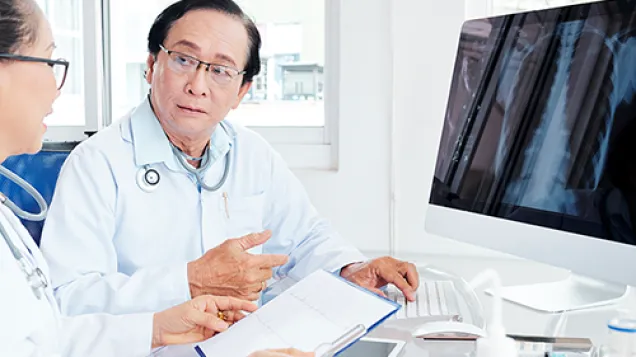 Asian doctors looking at x-ray