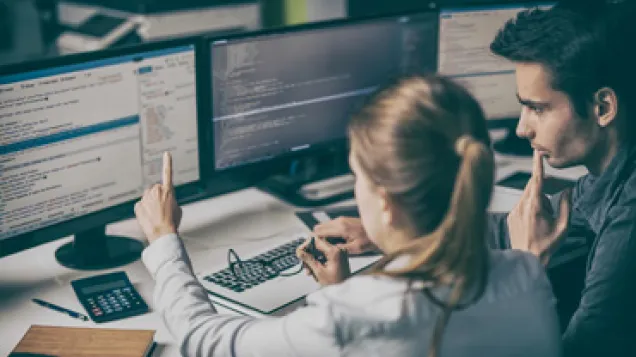 experts looking at a computer screen