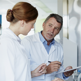 Three doctors discussing document