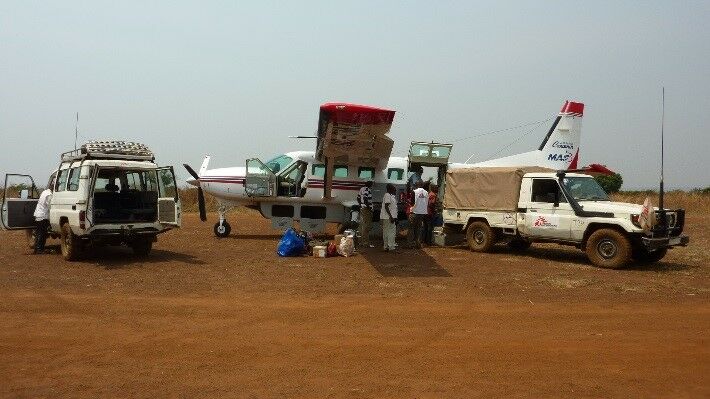 EPIET Postcard from the field - Plane and aid workers during measles outbreak, DRC