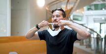Man putting on face mask
