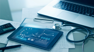 Tablet with data next to laptop