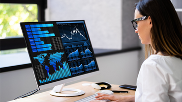 Female doctor typing and looking at data on screen