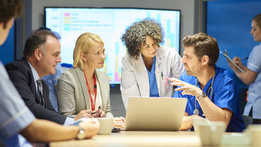 Doctors discussing by laptop